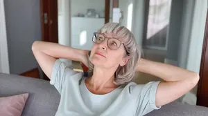 Woman stretching peacefully in a bright room feeling emotionally calmer after stopping nightly drinking