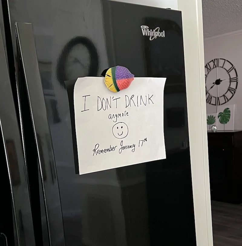 Handwritten "I don't drink anymore" reminder attached to a refrigerator door as part of an after-work drinking trigger plan.