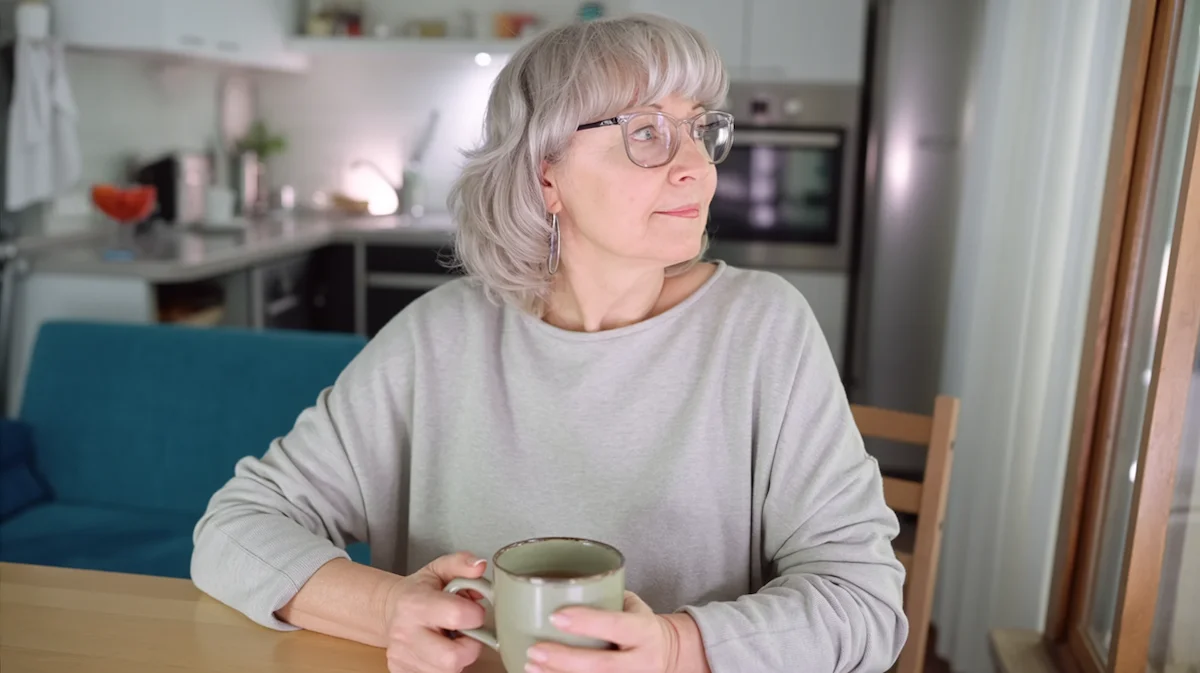 Considering Alternatives to AA Woman quietly reflecting at a kitchen table while considering alternatives to AA