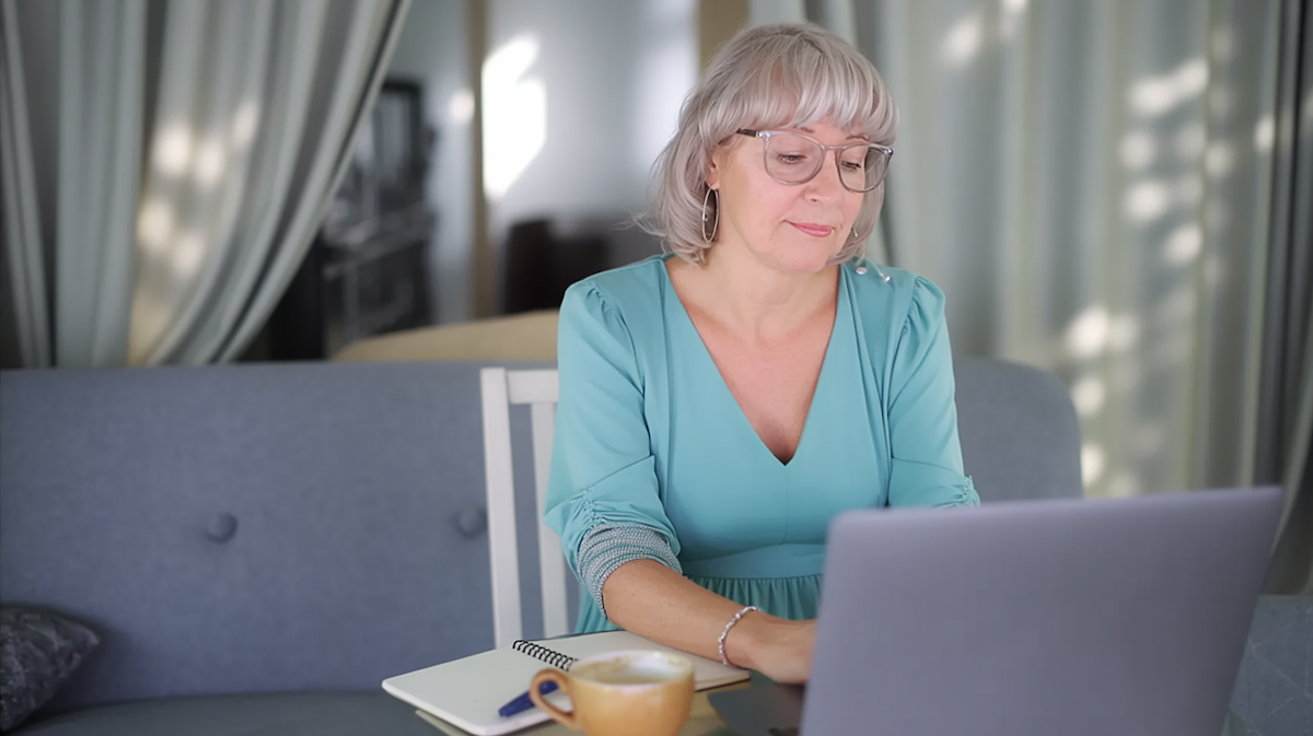 Susan Gast working at her laptop at home, representing a calm alcohol-free lifestyle