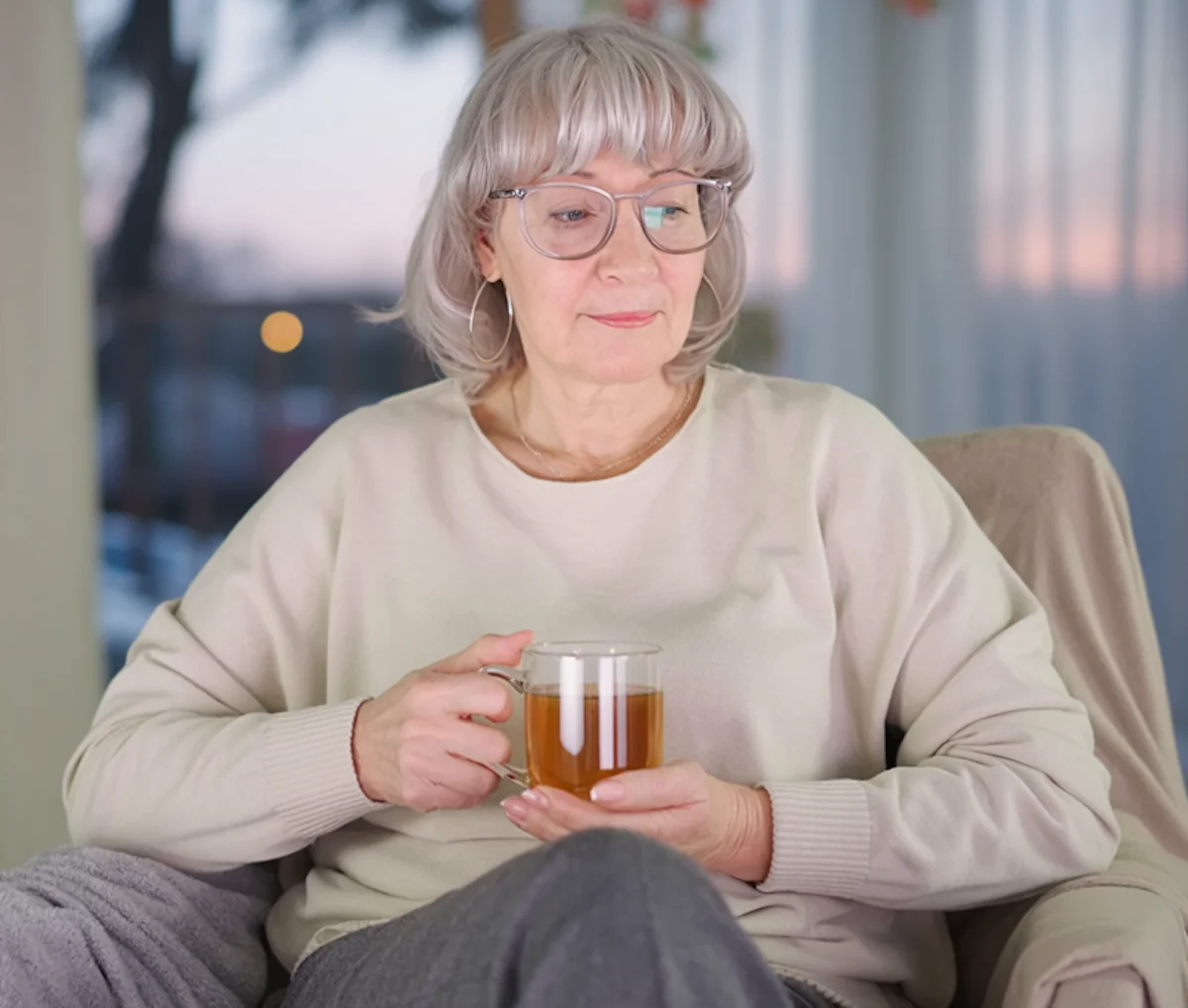 Woman sitting calmly in the evening, choosing not to drink and staying in control