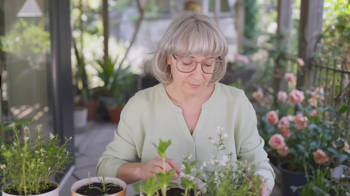 Rediscovering Peace in Everyday Life Woman peacefully gardening at home while building healthier evening habits after quitting drinking