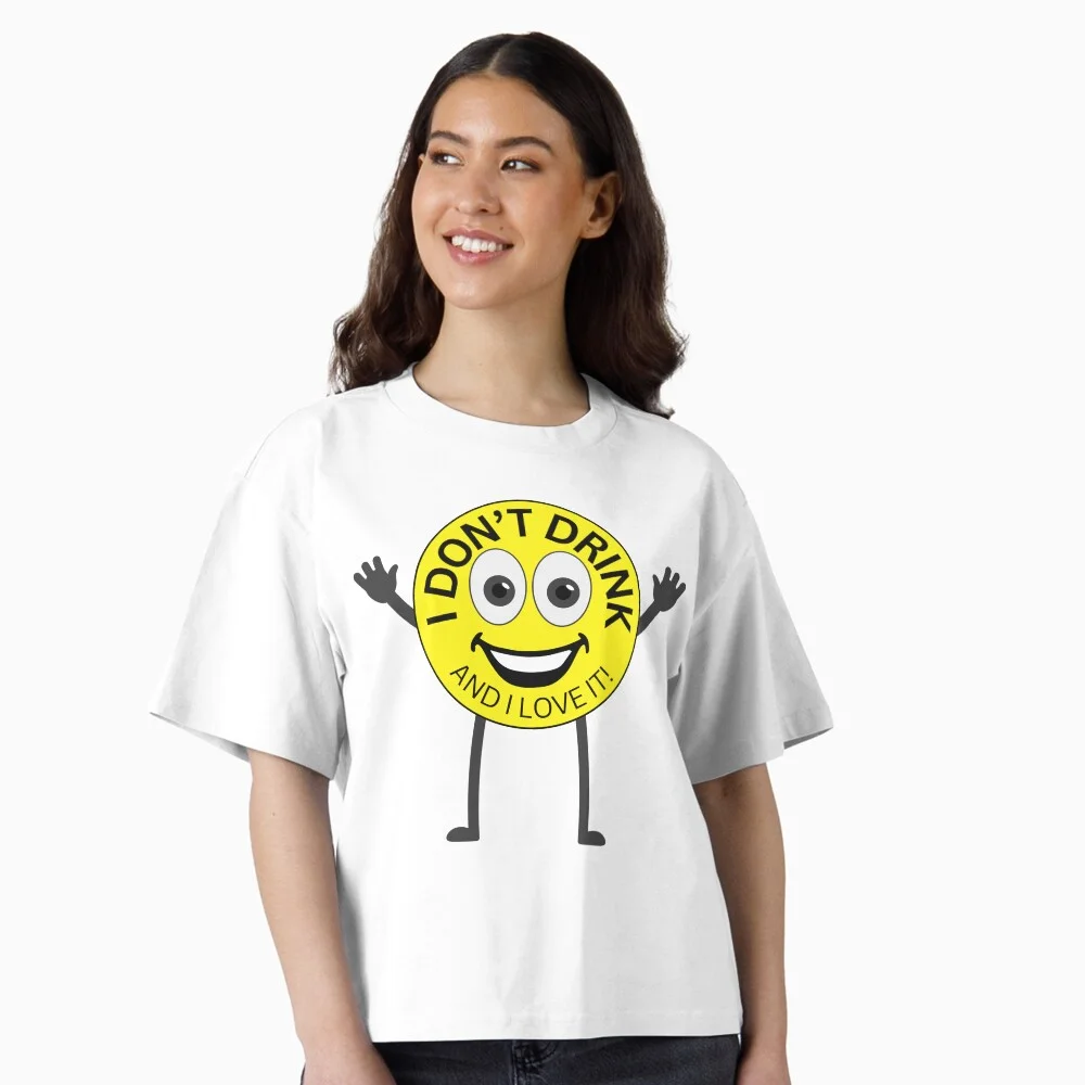 Woman wearing a funny “I Don’t Drink and I Love It” sober smiley face T-shirt with arms and legs.