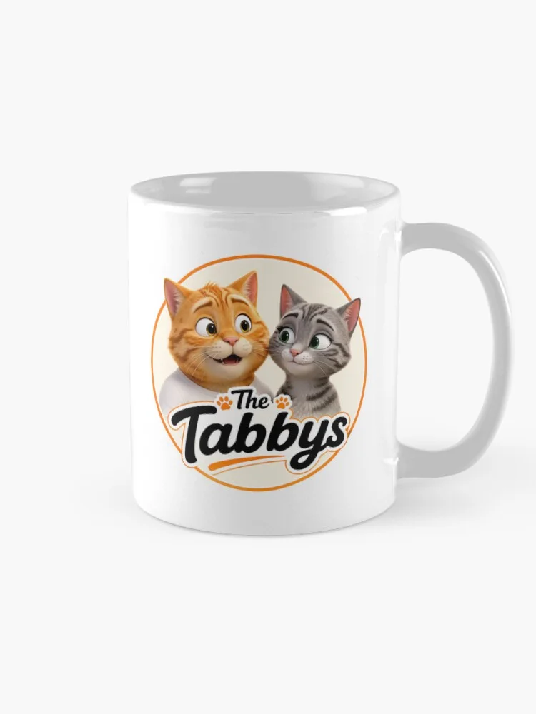 White classic mug featuring The Tabbys logo with George and Maggie the tabby cats.