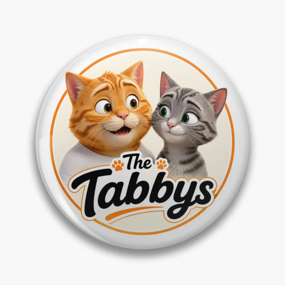 Round pin featuring The Tabbys logo with George and Maggie the tabby cats.